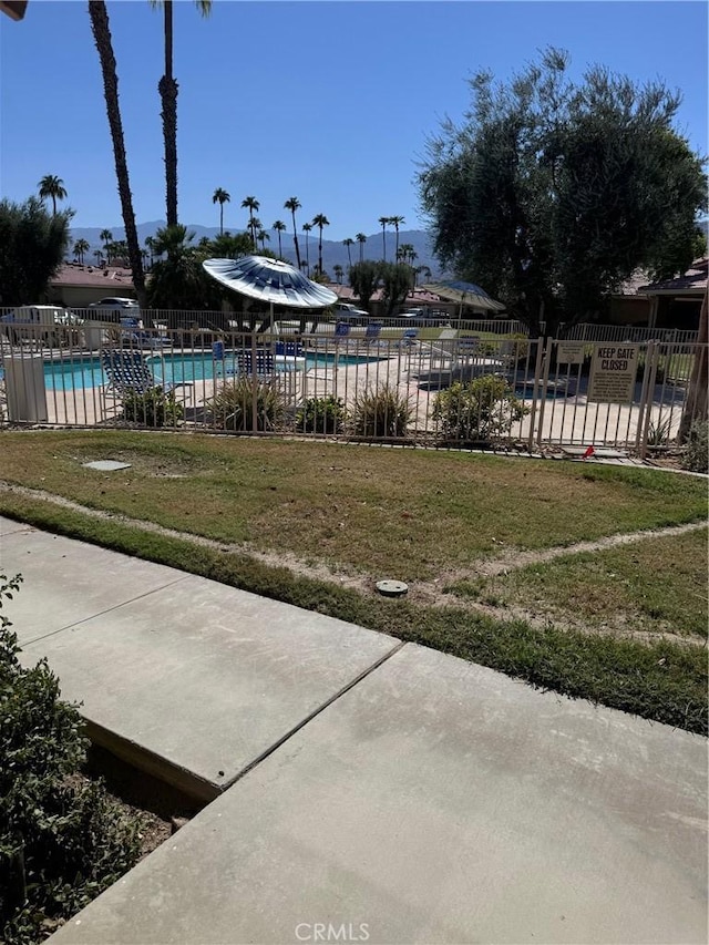 view of yard with a community pool and a patio