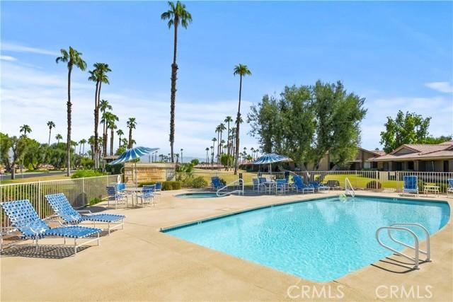 view of swimming pool with a community hot tub and a patio area