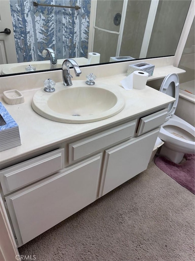 bathroom with vanity, walk in shower, and toilet