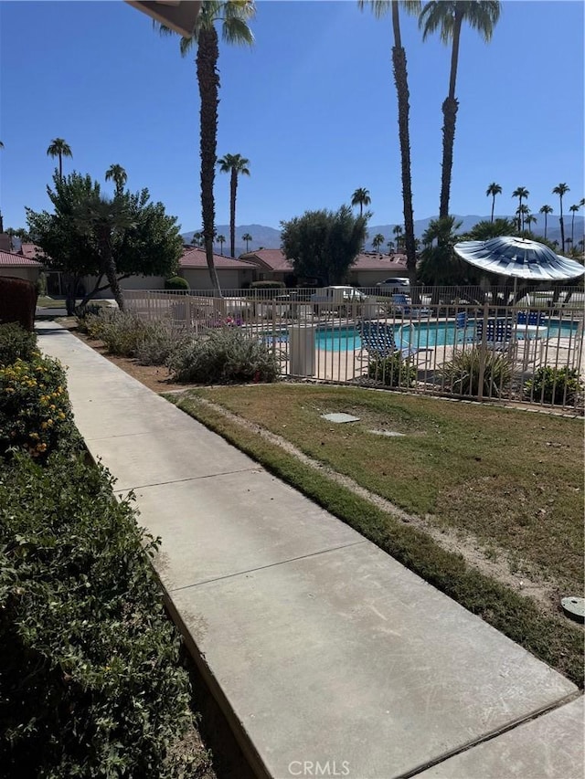 exterior space with a pool and a lawn