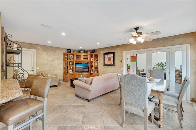 living room with ceiling fan and french doors