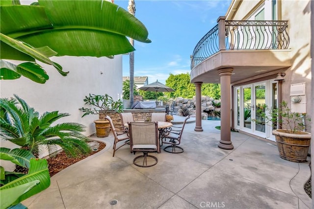 view of patio featuring french doors and a balcony