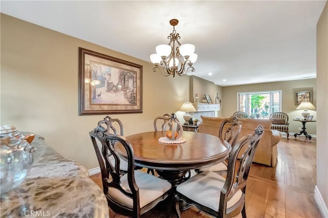 dining space featuring an inviting chandelier and light hardwood / wood-style flooring