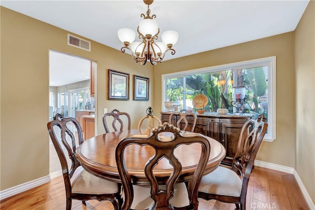 dining area featuring a chandelier and light hardwood / wood-style flooring