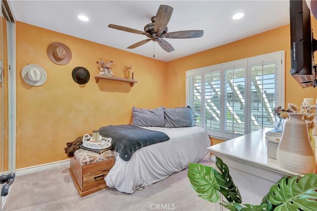 bedroom featuring light colored carpet and ceiling fan