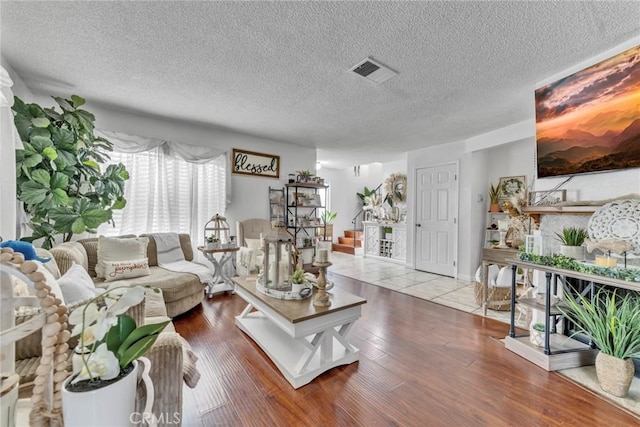 living room featuring a textured ceiling and hardwood / wood-style flooring