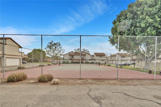 view of tennis court with fence