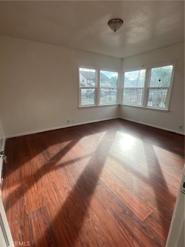 spare room with dark hardwood / wood-style flooring