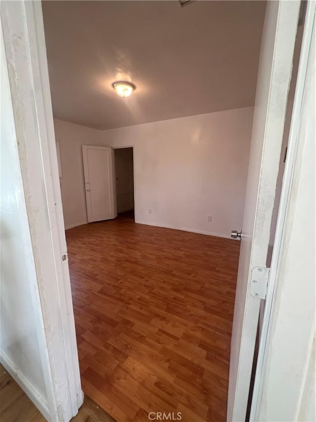 empty room with dark hardwood / wood-style flooring