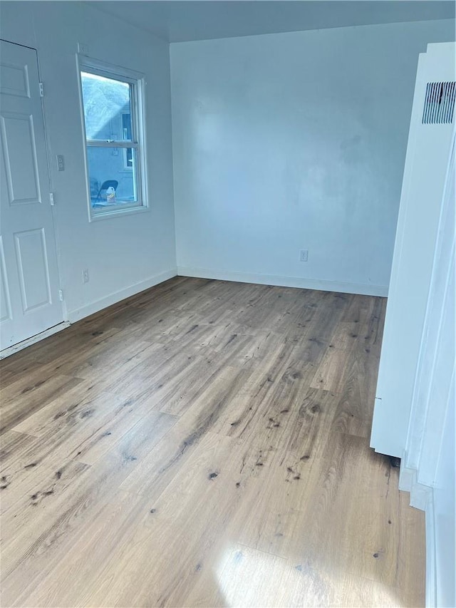 spare room featuring light wood-type flooring