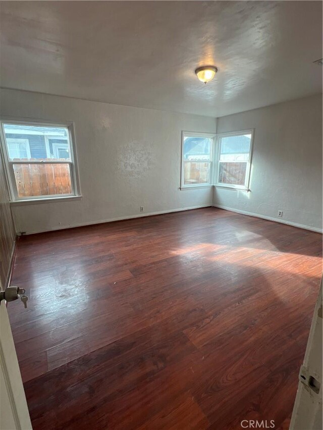 spare room with dark hardwood / wood-style floors