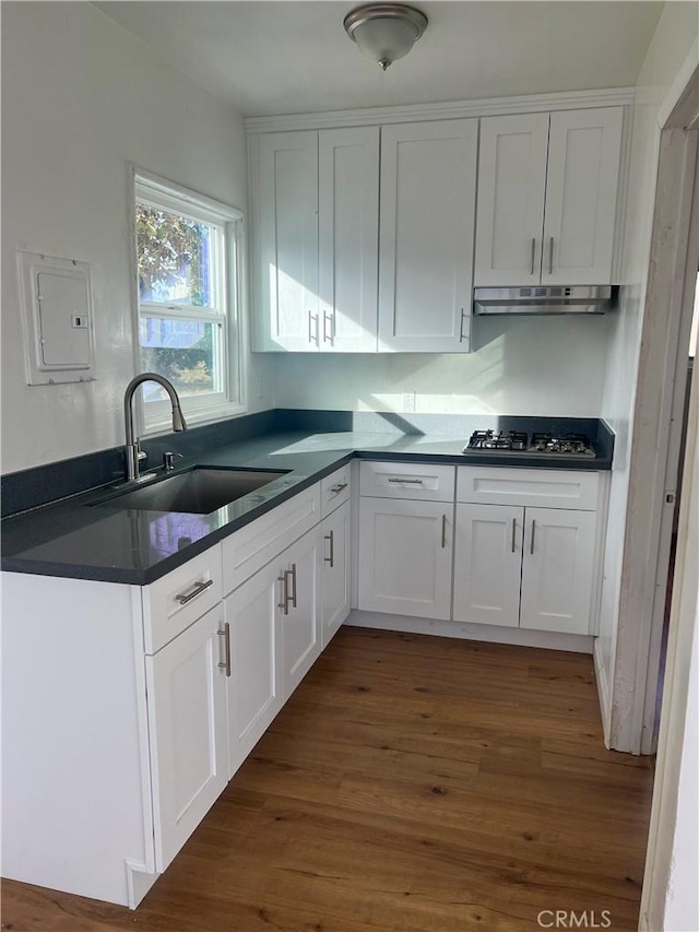 kitchen featuring white cabinetry, sink, dark wood-type flooring, stainless steel gas cooktop, and electric panel