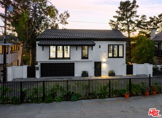 view of front of home with a balcony and a garage