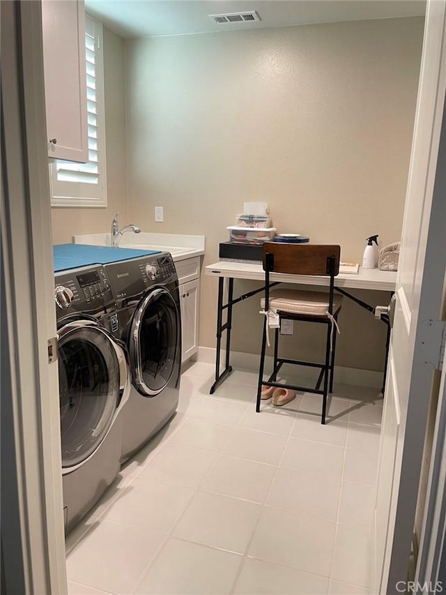 clothes washing area with cabinets, independent washer and dryer, sink, and light tile patterned floors