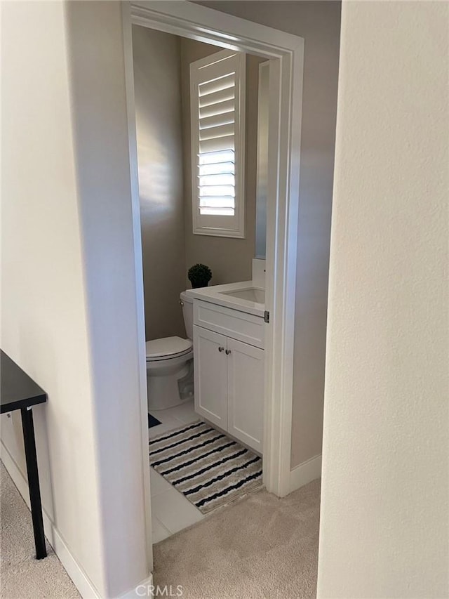 bathroom featuring vanity and toilet