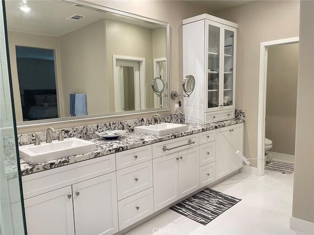 bathroom with tile patterned floors, vanity, and toilet