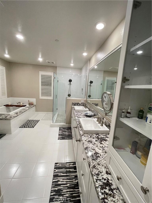 bathroom featuring tile patterned floors, vanity, and shower with separate bathtub