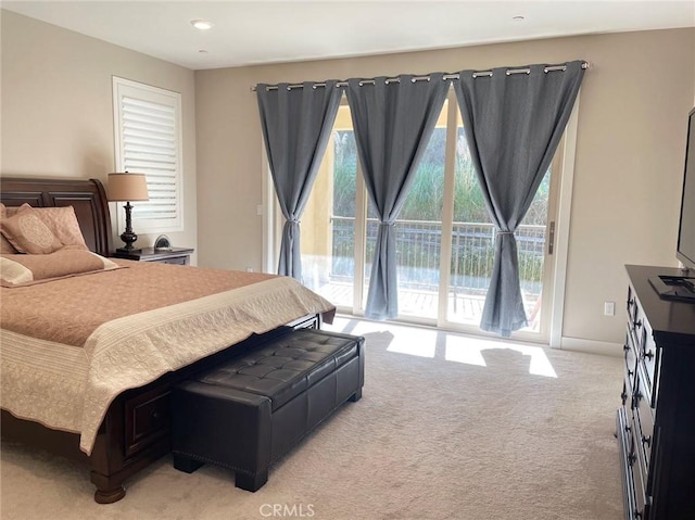 bedroom featuring light carpet and access to outside