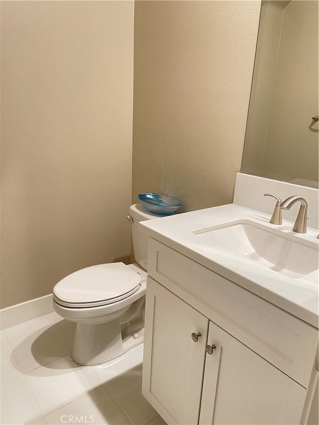 bathroom with tile patterned flooring, vanity, and toilet