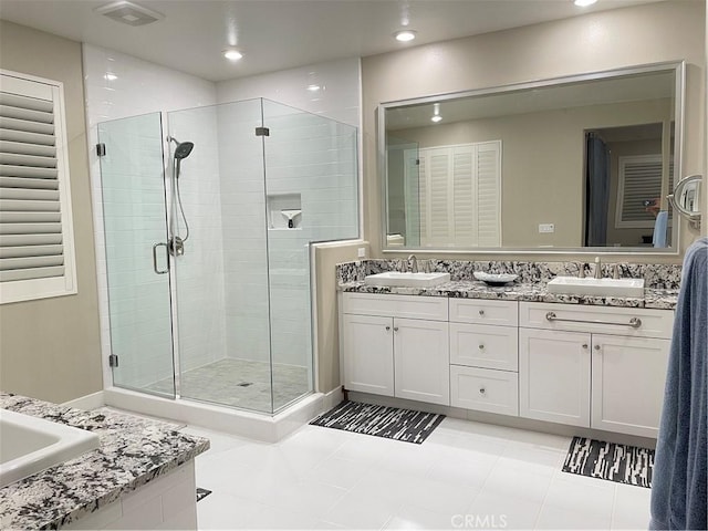 bathroom featuring tile patterned flooring, vanity, and separate shower and tub