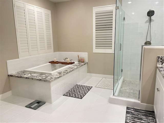 bathroom featuring tile patterned flooring, vanity, and plus walk in shower