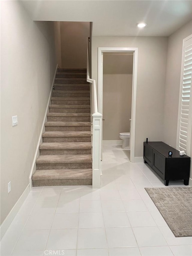 stairs featuring tile patterned floors