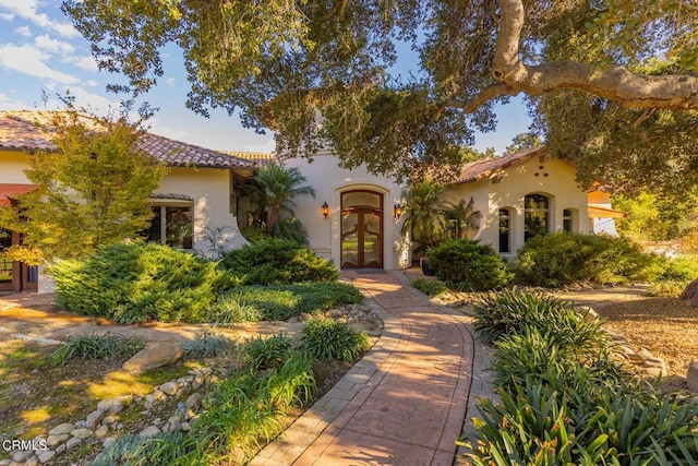 mediterranean / spanish-style home featuring french doors