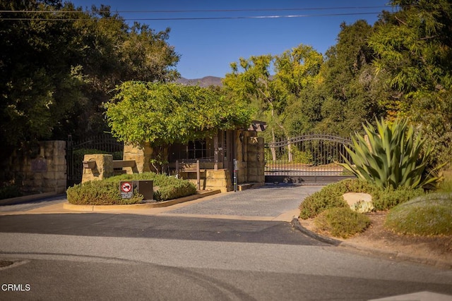 exterior space featuring a gate and a mountain view