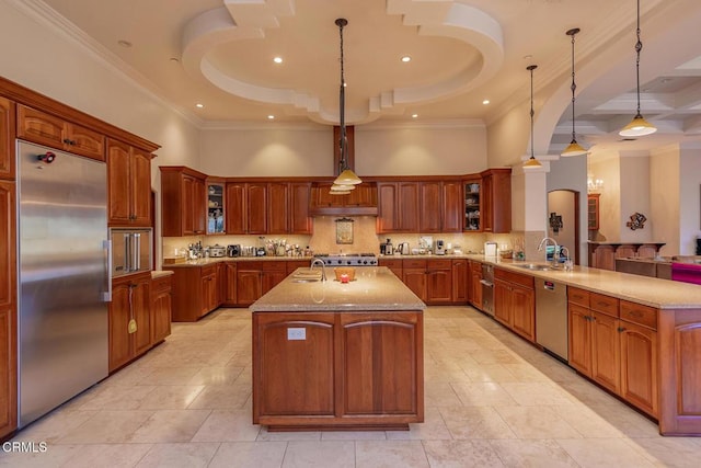 kitchen with a center island with sink, ornamental molding, a peninsula, stainless steel appliances, and a sink