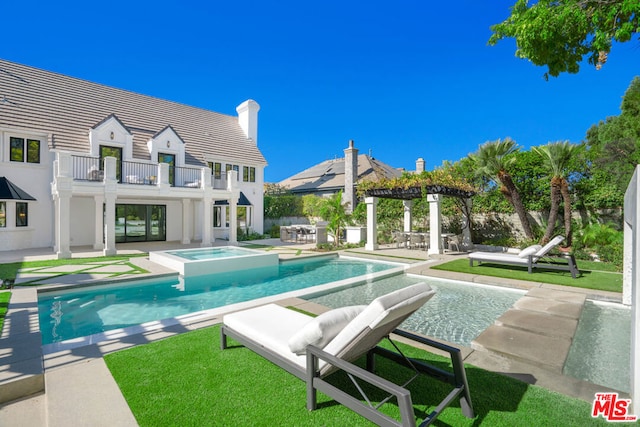 view of pool with a patio area and an in ground hot tub