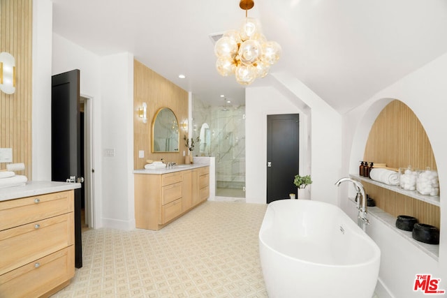 bathroom featuring a chandelier, vanity, and independent shower and bath