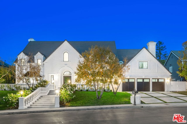 french country inspired facade featuring a front lawn