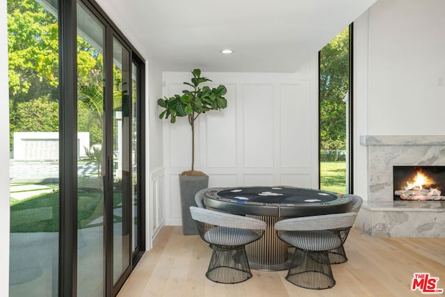 sunroom / solarium featuring a high end fireplace