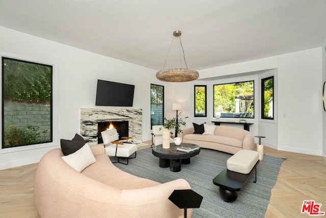 living room featuring light parquet flooring and a premium fireplace