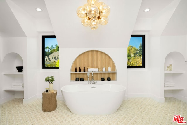 bathroom with built in shelves and a washtub