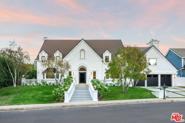 view of front facade with a lawn and a garage