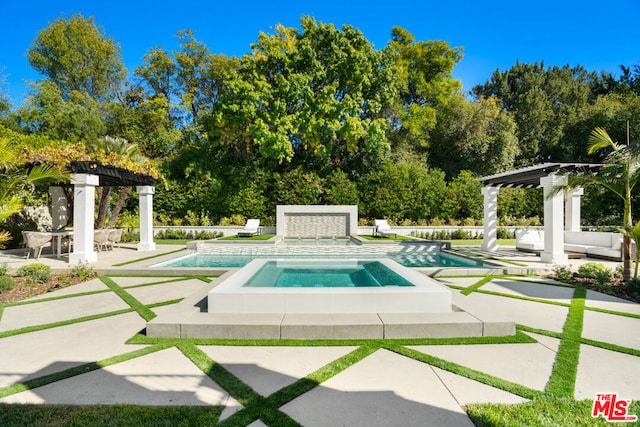 view of swimming pool featuring an in ground hot tub and a patio area