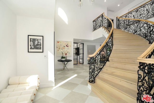 stairway with a towering ceiling