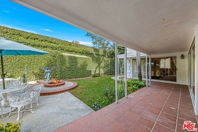 view of patio / terrace featuring an outdoor fire pit