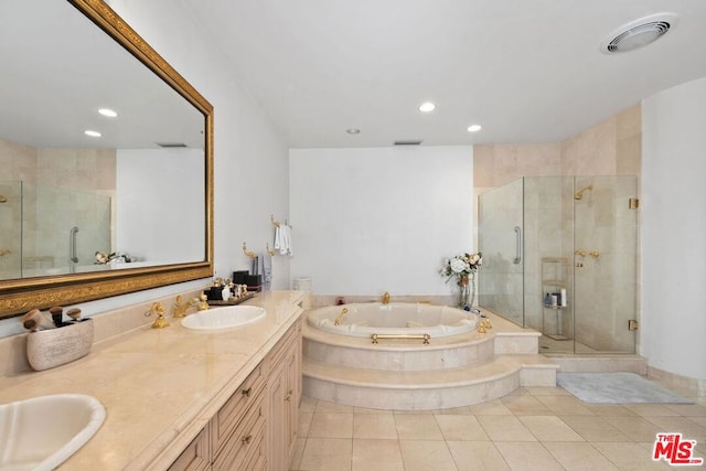 bathroom with tile patterned floors, vanity, and independent shower and bath