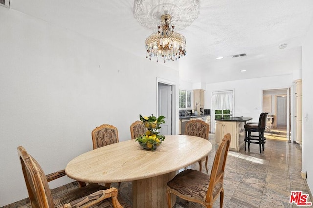 dining space featuring a chandelier