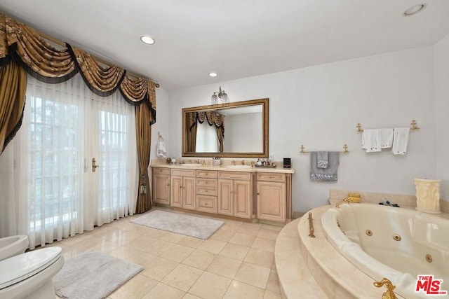 bathroom with tiled tub, tile patterned flooring, vanity, and toilet