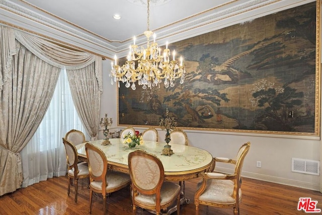 dining area with hardwood / wood-style floors, crown molding, and an inviting chandelier