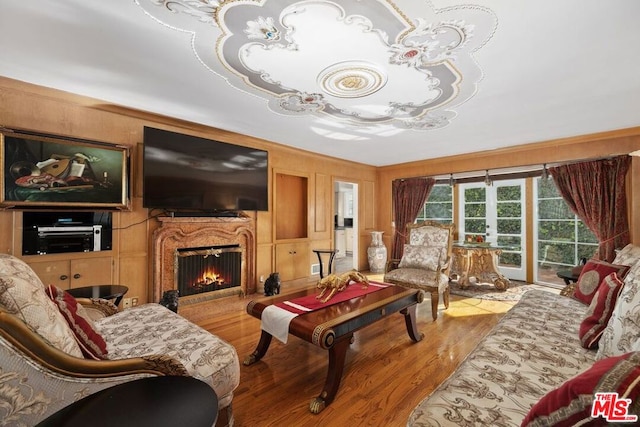 living room featuring hardwood / wood-style flooring and wooden walls