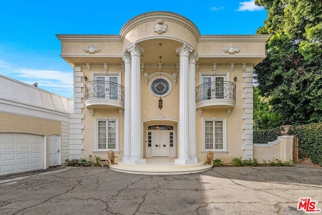 view of front of home featuring a balcony and a garage