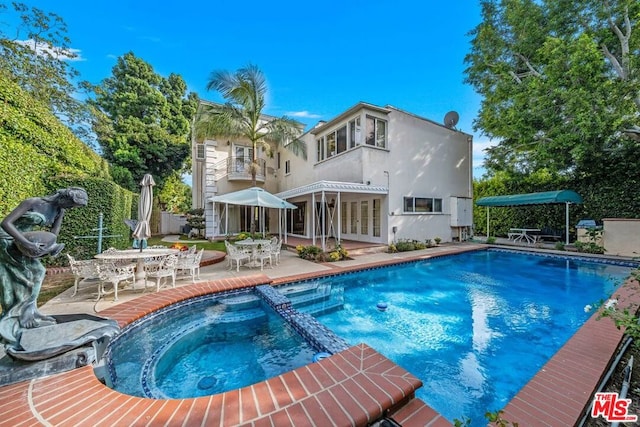 view of pool featuring an in ground hot tub and a patio