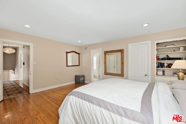 bedroom with hardwood / wood-style floors