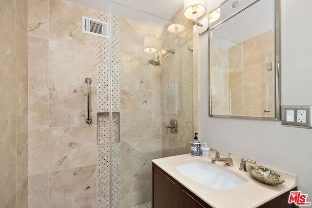 bathroom featuring vanity and a tile shower