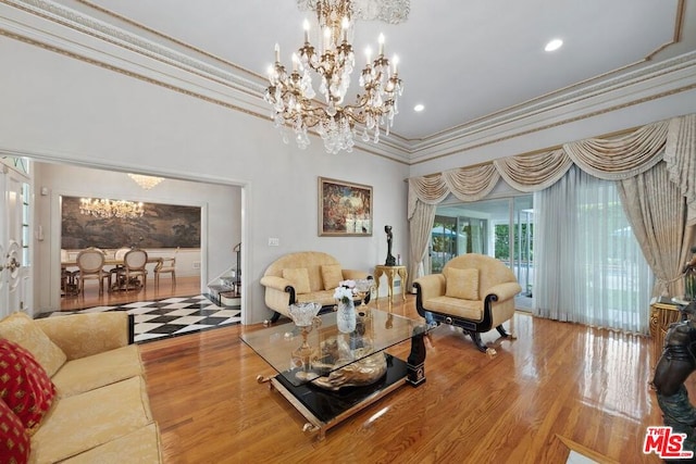 living room featuring a chandelier, crown molding, and wood-type flooring