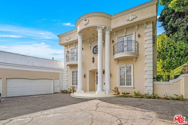 view of front of house with a balcony and a garage